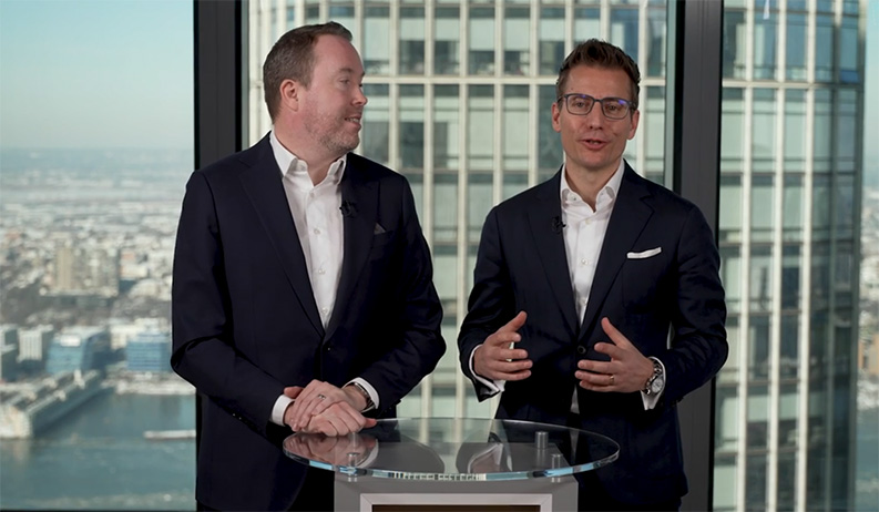 Doug Krupa and Markus Egloff standing at a podium discussing private markets. 